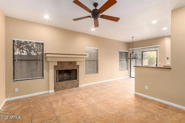 a view of an empty room with a fireplace and a window