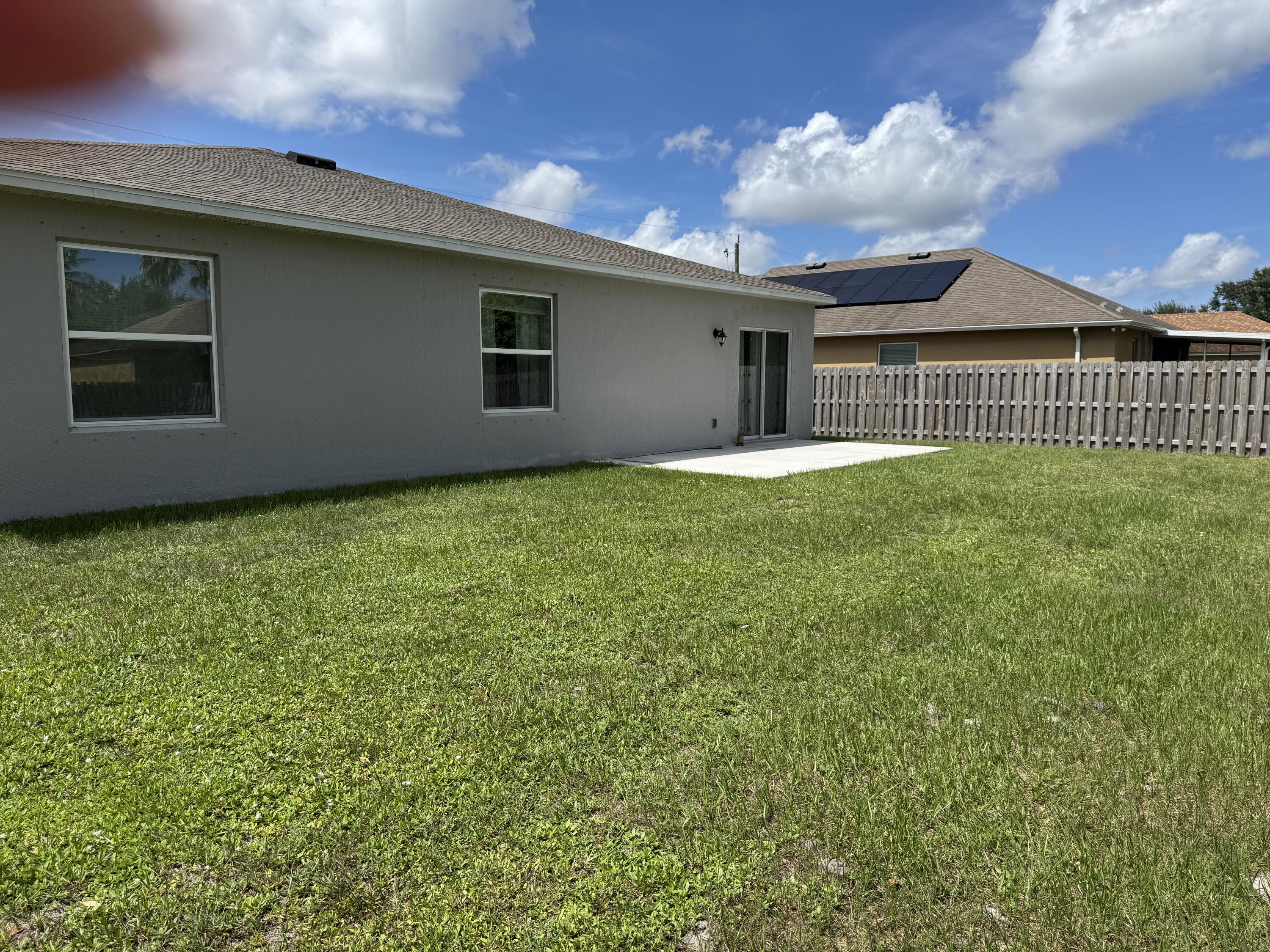 3725 Southwest Kasin Street Port St. Lucie, FL 34953 - Photo 15 of 18 a view of a house with backyard and garden