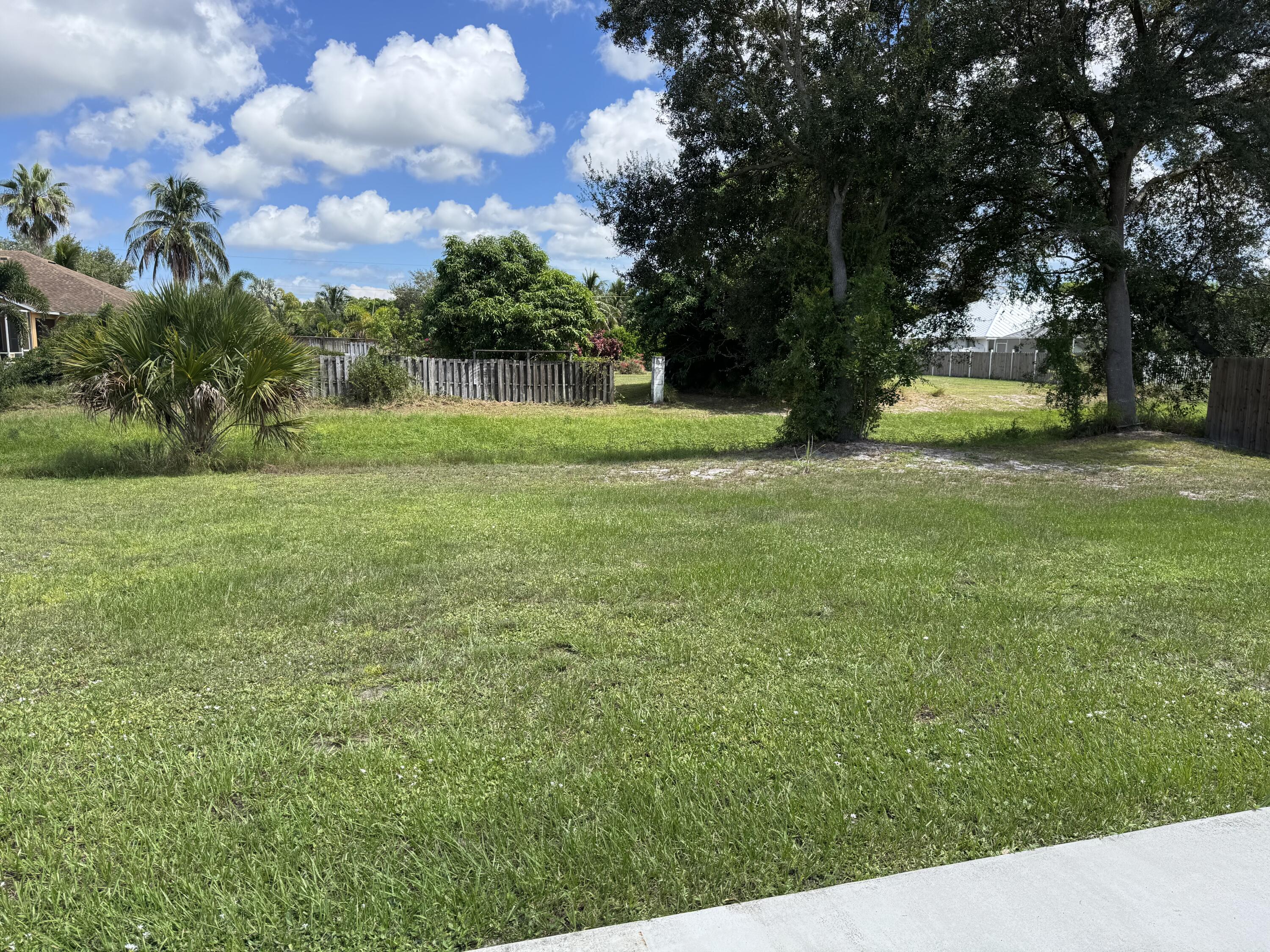 3725 Southwest Kasin Street Port St. Lucie, FL 34953 - Photo 16 of 18 a view of a yard with a house in the background