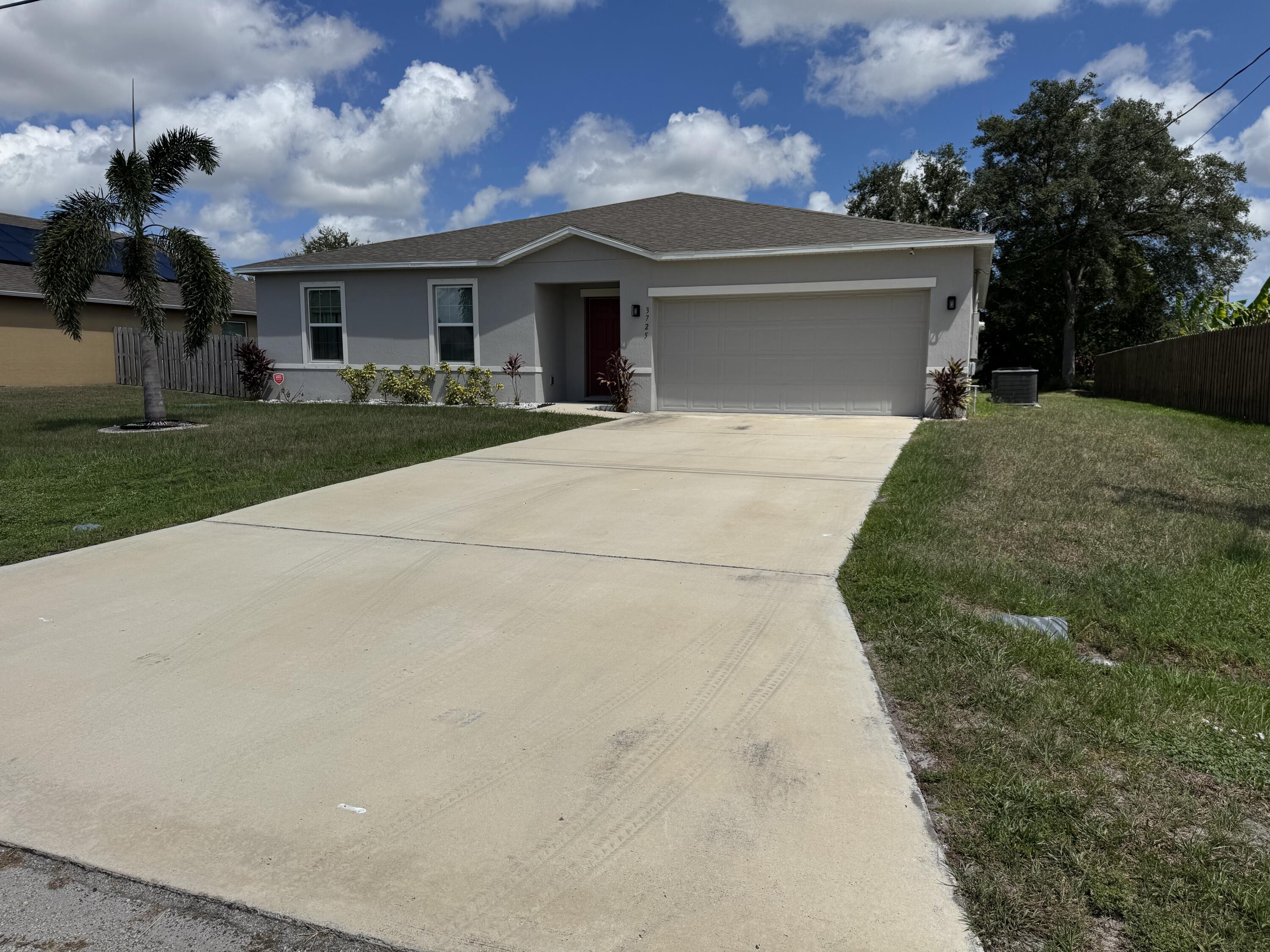 3725 Southwest Kasin Street Port St. Lucie, FL 34953 - Photo 2 of 18 a front view of house with yard