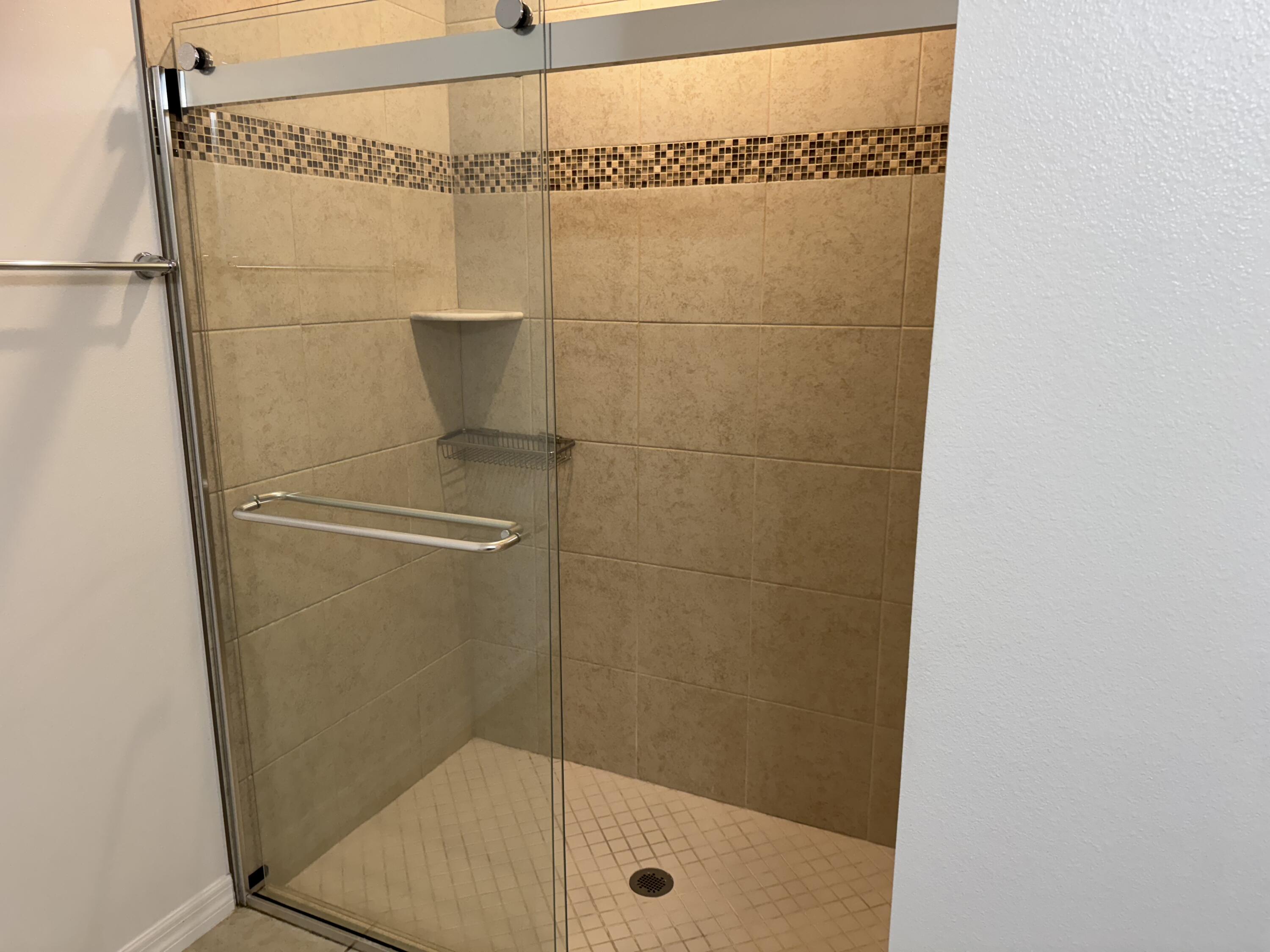 3725 Southwest Kasin Street Port St. Lucie, FL 34953 - Photo 9 of 18 a bathroom with a glass door shower