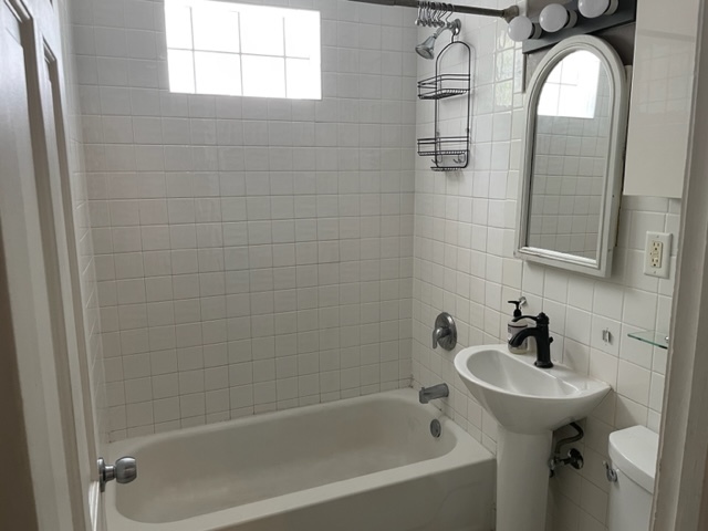 535 Kendall Lane DeKalb, IL 60115 - Photo 12 of 14 a bathroom with a sink a mirror a bathtub and shower
