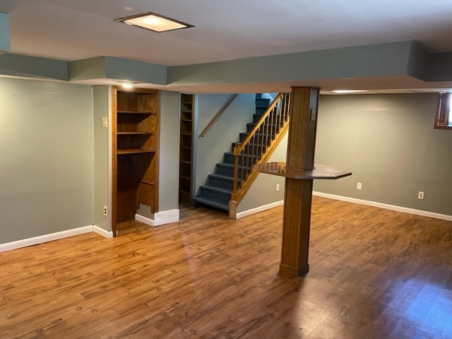 535 Kendall Lane DeKalb, IL 60115 - Photo 14 of 14 a view of an empty room with stairs and wooden floor