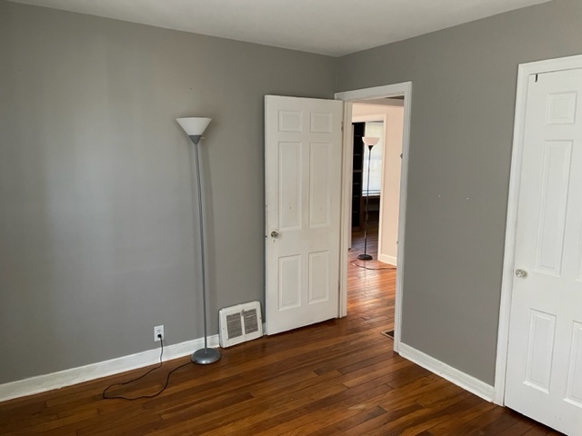 535 Kendall Lane DeKalb, IL 60115 - Photo 7 of 14 a view of an empty room with wooden floor and closet