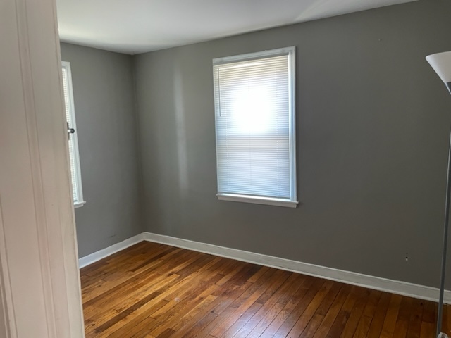535 Kendall Lane DeKalb, IL 60115 - Photo 8 of 14 a view of empty room with wooden floor and fan