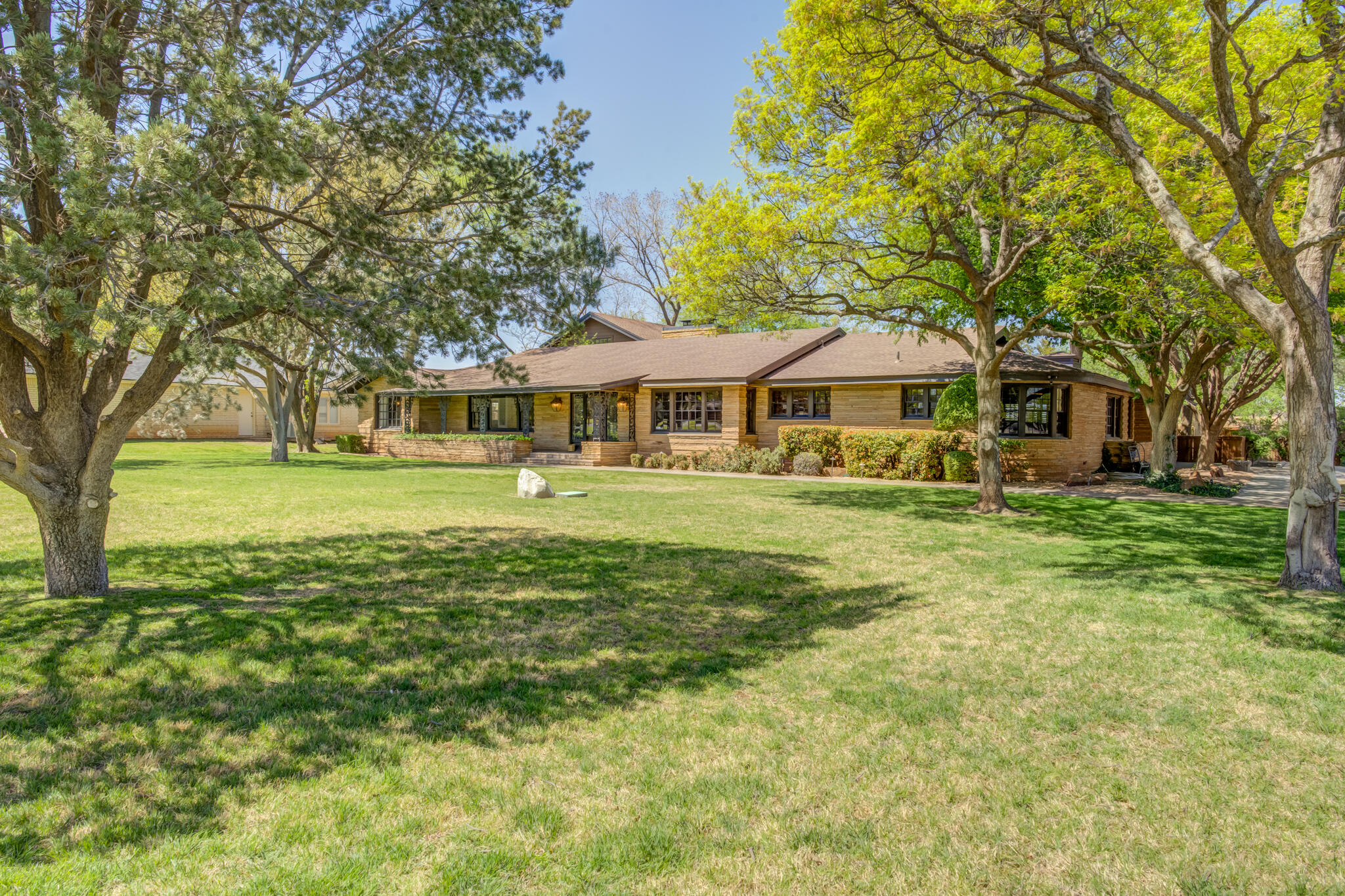 a front view of a building with a garden