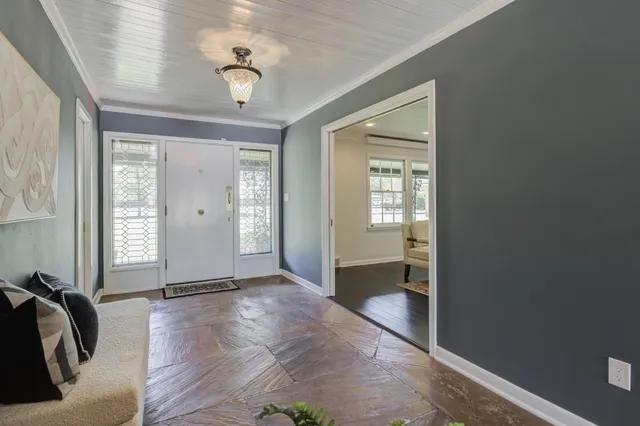 a view of a dining room with furniture and chandelier