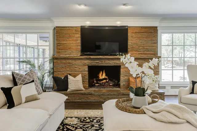 a spacious bedroom with a bed and a chandelier