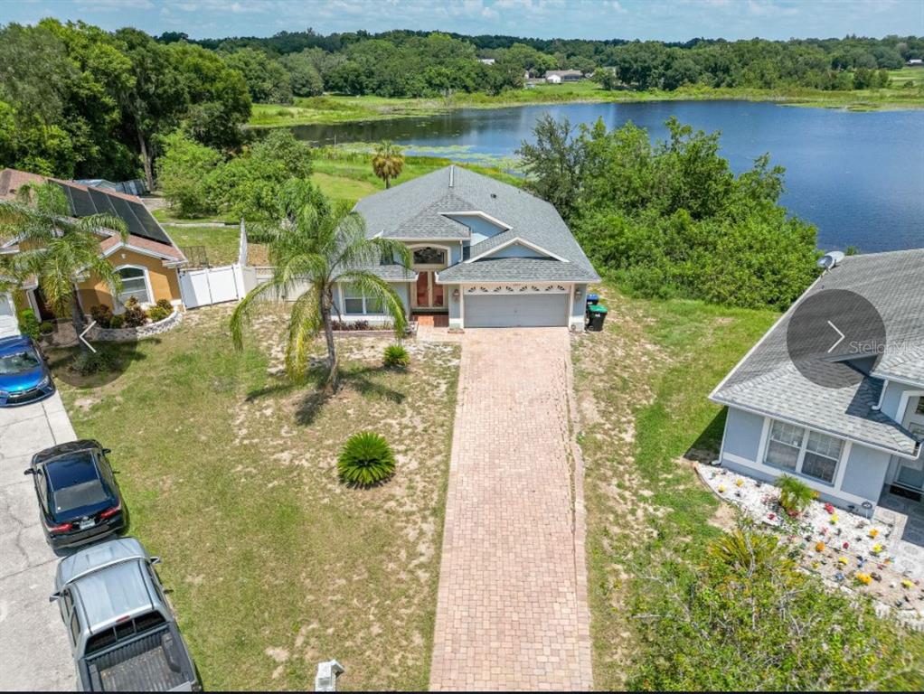 6569 Long Breeze Road Orlando, FL 32810 - Photo 1 of 1 an aerial view of a house with lake view