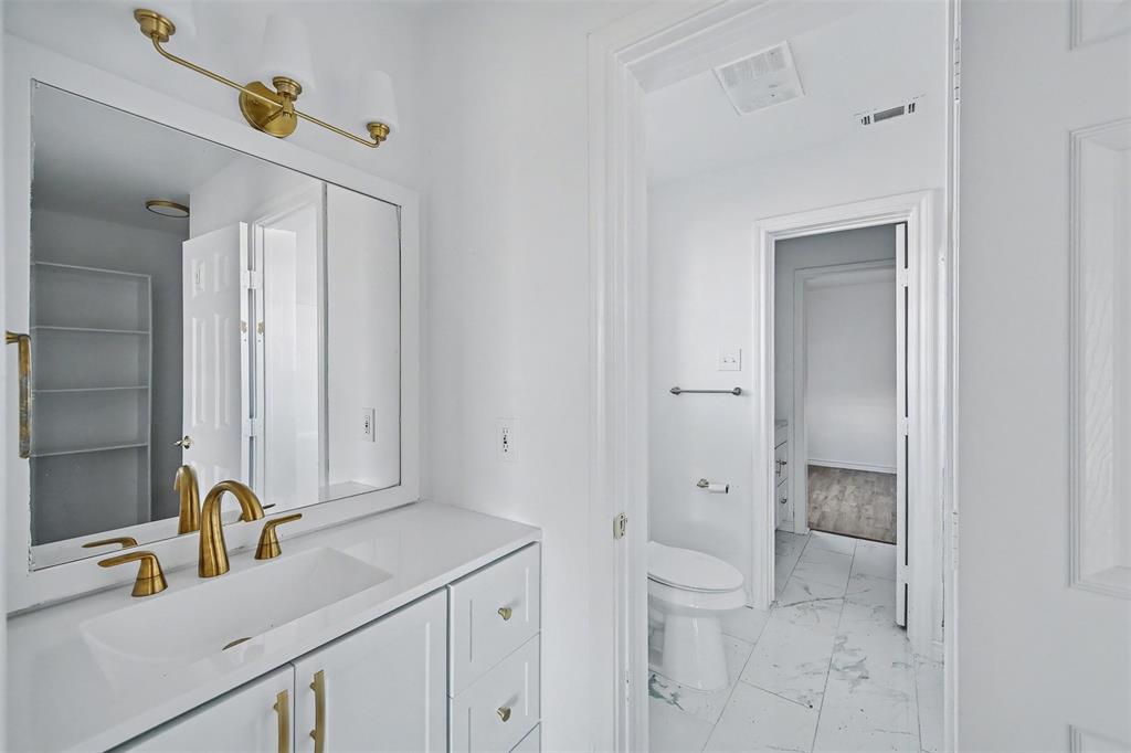 1781 South Munson Road Royse City, TX 75189 - Photo 11 of 33 a bathroom with a sink and mirror with toilet