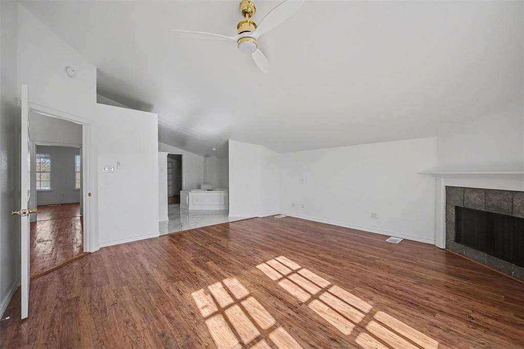 1781 South Munson Road Royse City, TX 75189 - Photo 19 of 33 a view of empty room with wooden floor and fireplace