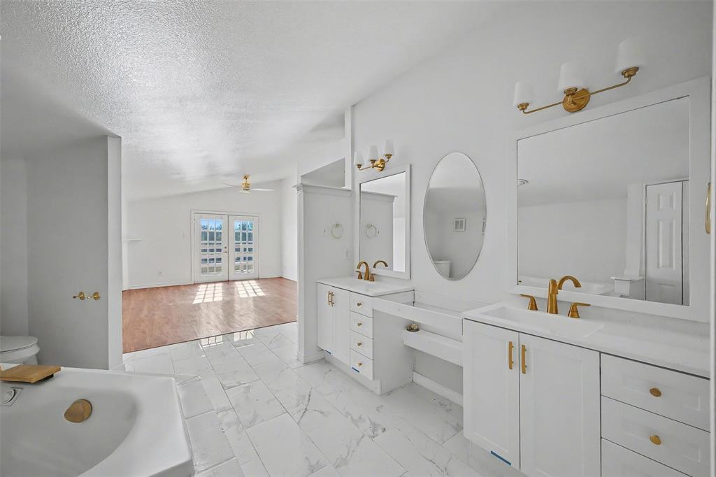 1781 South Munson Road Royse City, TX 75189 - Photo 21 of 33 a spacious bathroom with a granite countertop sink a mirror and bathtub