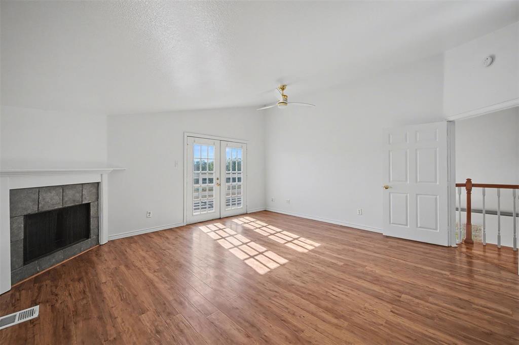 1781 South Munson Road Royse City, TX 75189 - Photo 22 of 33 a view of empty room with wooden floor and fireplace