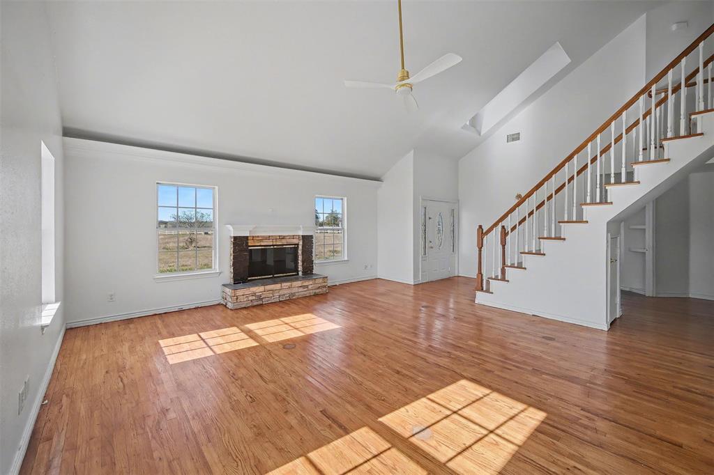1781 South Munson Road Royse City, TX 75189 - Photo 7 of 33 a view of empty room with wooden floor and fireplace