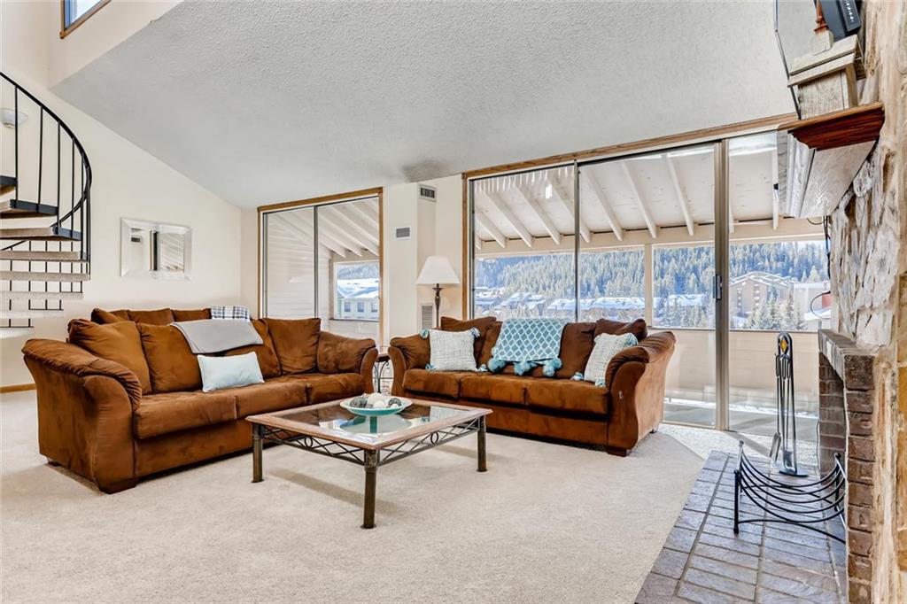 760 Copper Road, Unit 201 Copper Mountain, CO 80443 - Photo 2 of 28 a living room with furniture and a large window