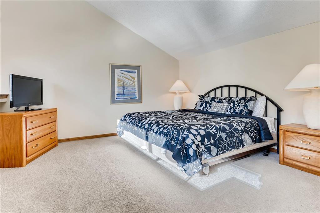 760 Copper Road, Unit 201 Copper Mountain, CO 80443 - Photo 18 of 28 a bedroom with a bed and a flat screen tv