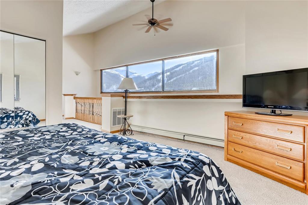 760 Copper Road, Unit 201 Copper Mountain, CO 80443 - Photo 19 of 28 a bedroom with a bed and flat screen tv