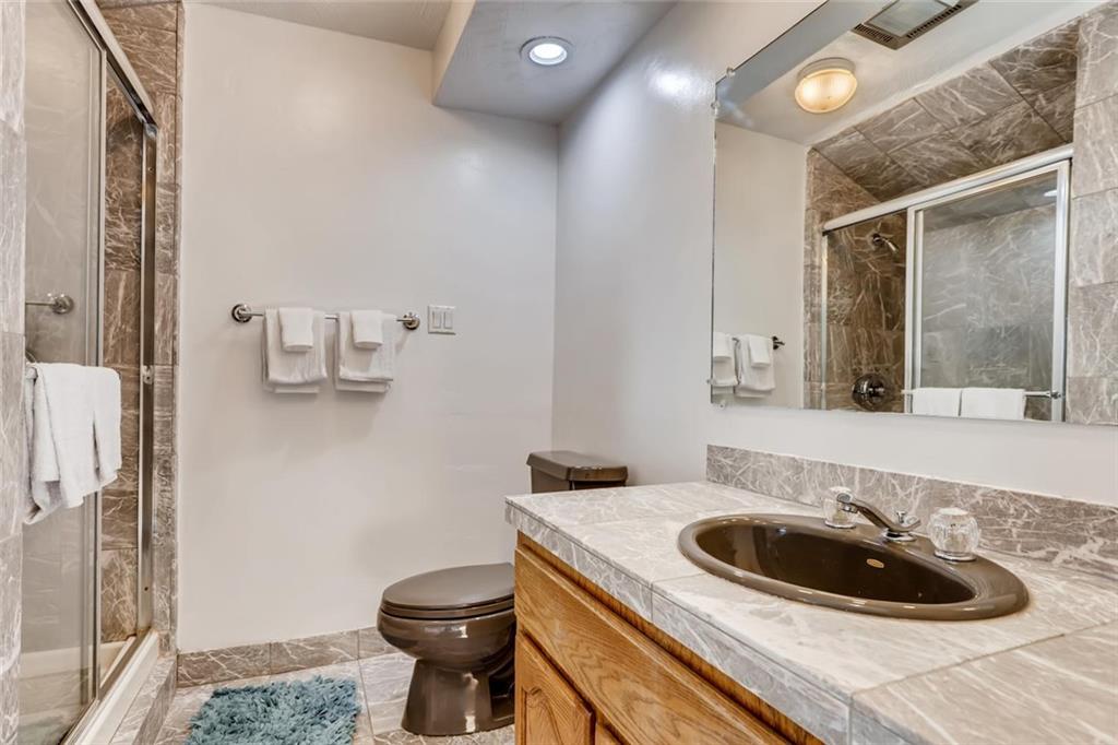 760 Copper Road, Unit 201 Copper Mountain, CO 80443 - Photo 20 of 28 a bathroom with a granite countertop sink a toilet and a mirror