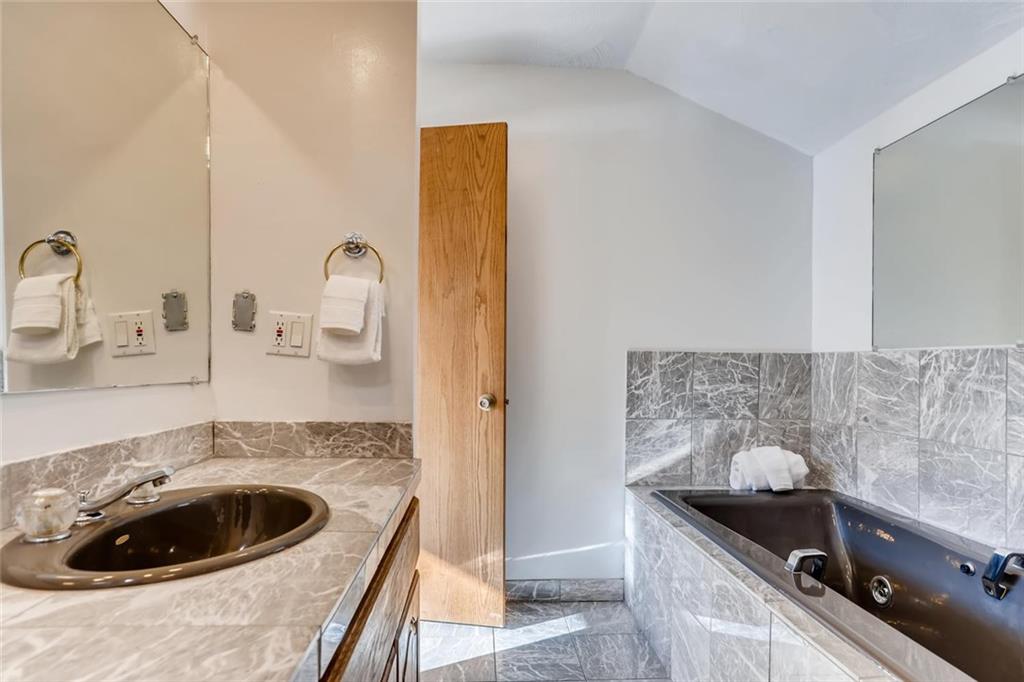 760 Copper Road, Unit 201 Copper Mountain, CO 80443 - Photo 21 of 28 a kitchen with a sink and a stove with wooden floor