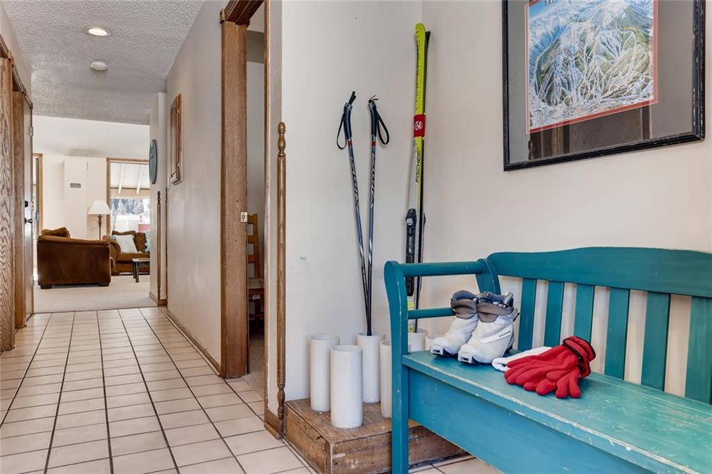 760 Copper Road, Unit 201 Copper Mountain, CO 80443 - Photo 5 of 28 a hallway with a book shelf