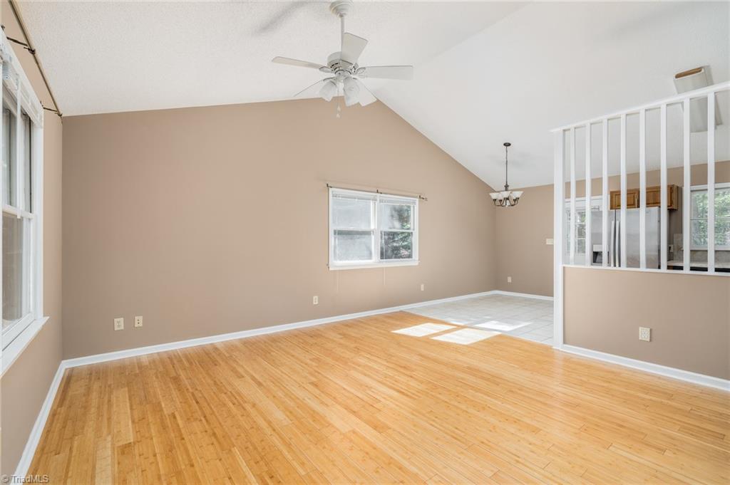 1003 Country Place Road Asheboro, NC 27203 - Photo 7 of 30 Living room featuring hard surface wood floors and vaulted ceiling.