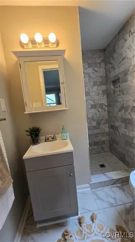a bathroom with a sink a mirror and shower