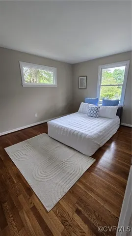 a bedroom with double bed and a window