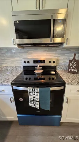 a stove top oven sitting inside of a kitchen