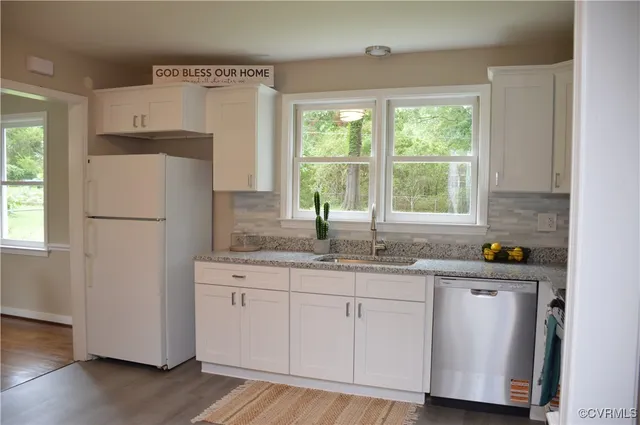 a kitchen with stainless steel appliances granite countertop a refrigerator sink and cabinets