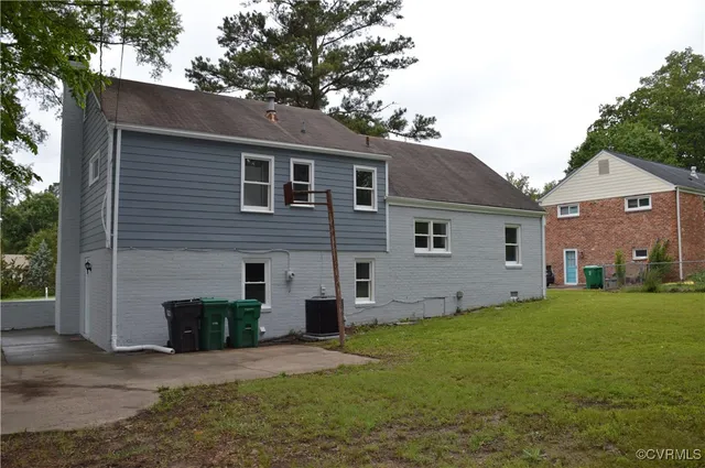 a front view of a house with a garden and yard