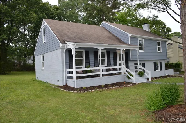 a view of a house with a yard patio and a garden