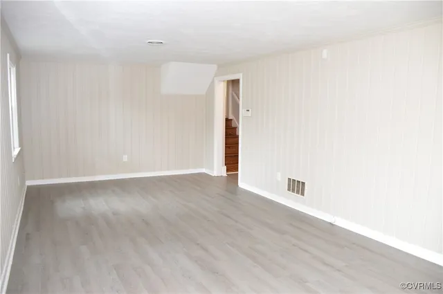 a view of a room with wooden floor