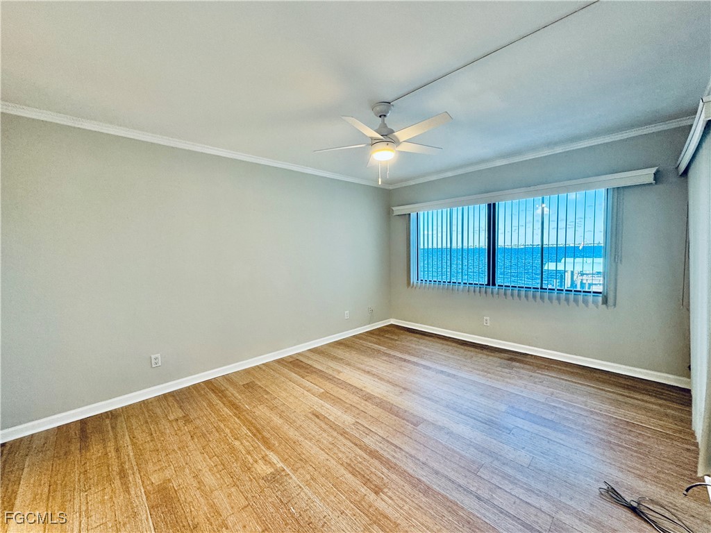 2711 First Street, Unit 102 Fort Myers, FL 33916 - Photo 11 of 36 an empty room with wooden floor and windows