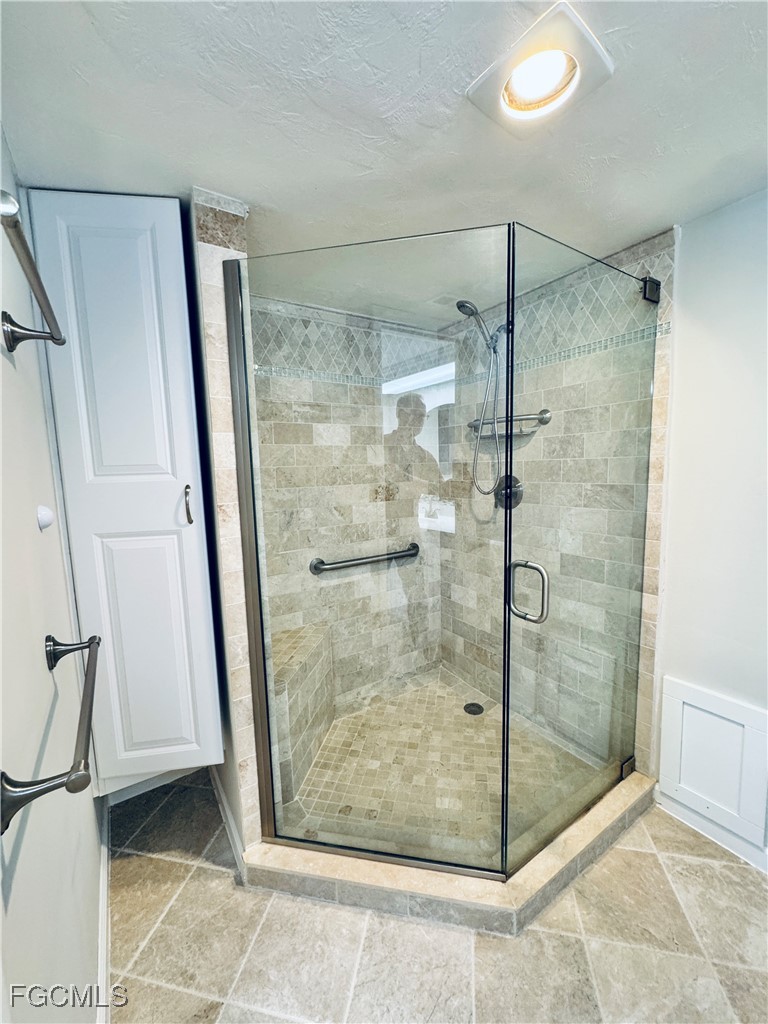 2711 First Street, Unit 102 Fort Myers, FL 33916 - Photo 17 of 36 a bathroom with a glass shower door