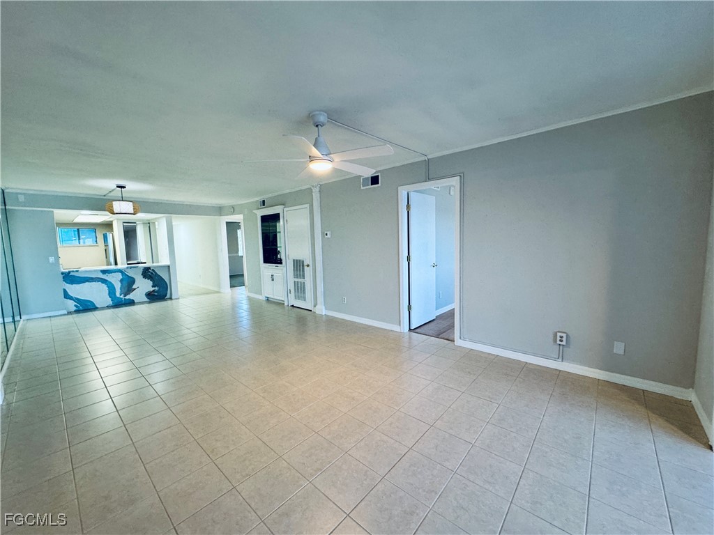 2711 First Street, Unit 102 Fort Myers, FL 33916 - Photo 4 of 36 an empty room with a garage and a fireplace