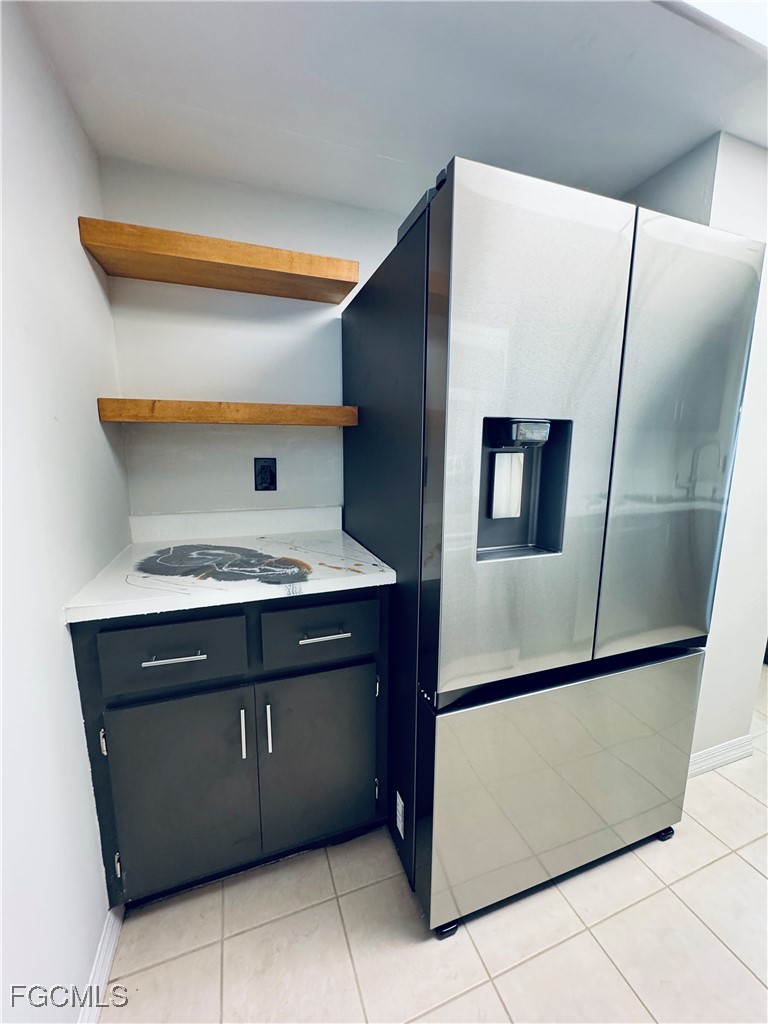 2711 First Street, Unit 102 Fort Myers, FL 33916 - Photo 9 of 36 a kitchen with stainless steel appliances a refrigerator and a stove