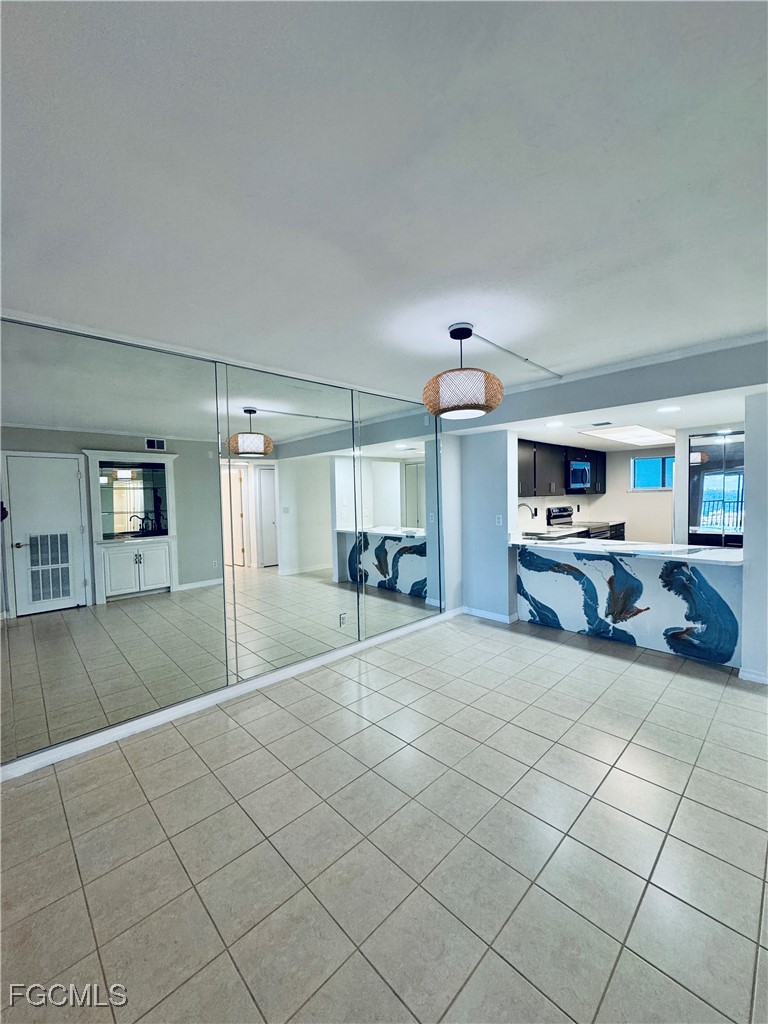2711 First Street, Unit 102 Fort Myers, FL 33916 - Photo 10 of 36 a living room with furniture and a flat screen tv