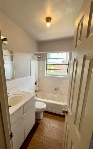 a bathroom with a sink a bathtub and toilet