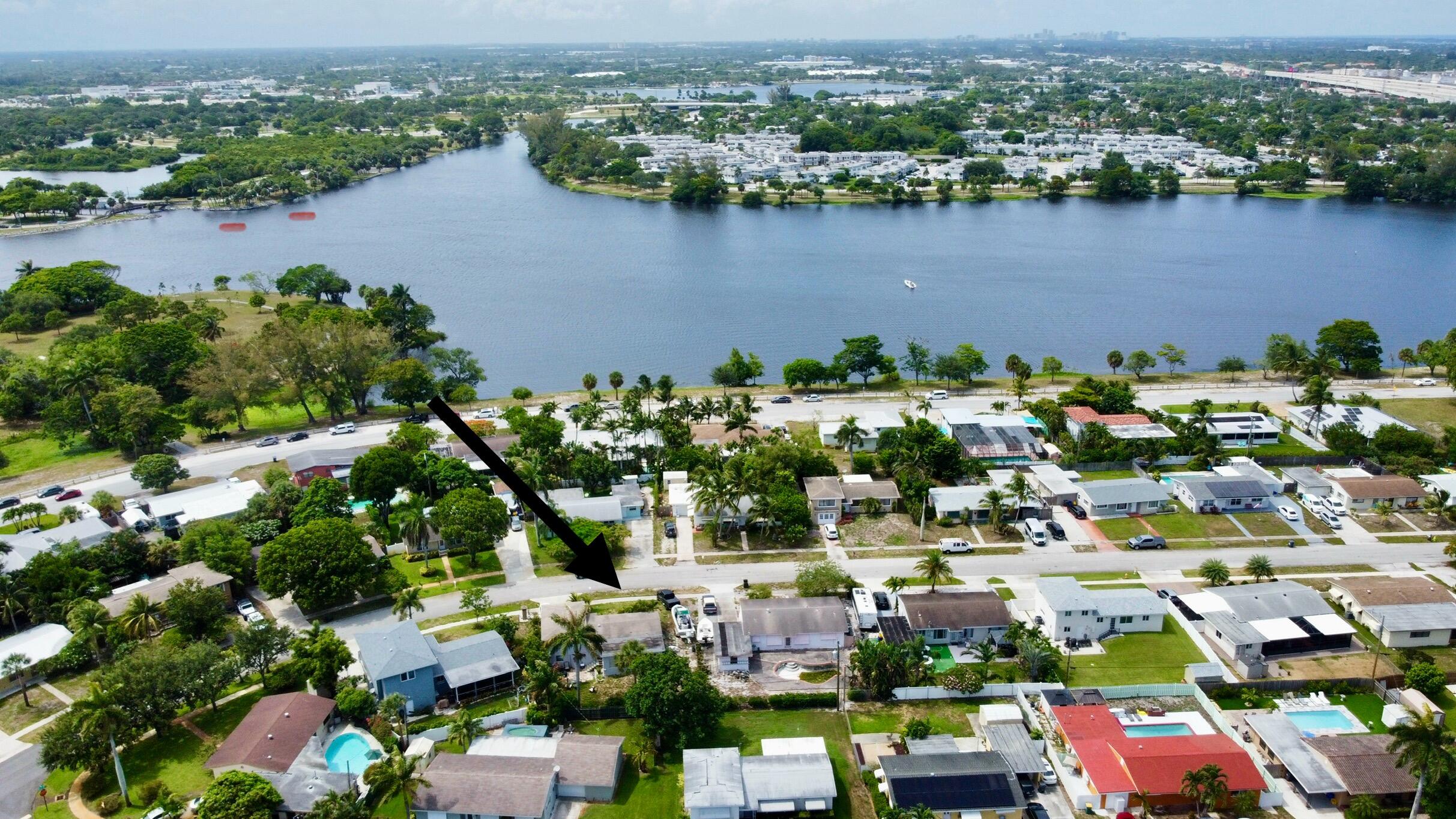 1424 Crest Drive Lake Worth, FL 33461 - Photo 16 of 16 an aerial view of a houses with a lake view