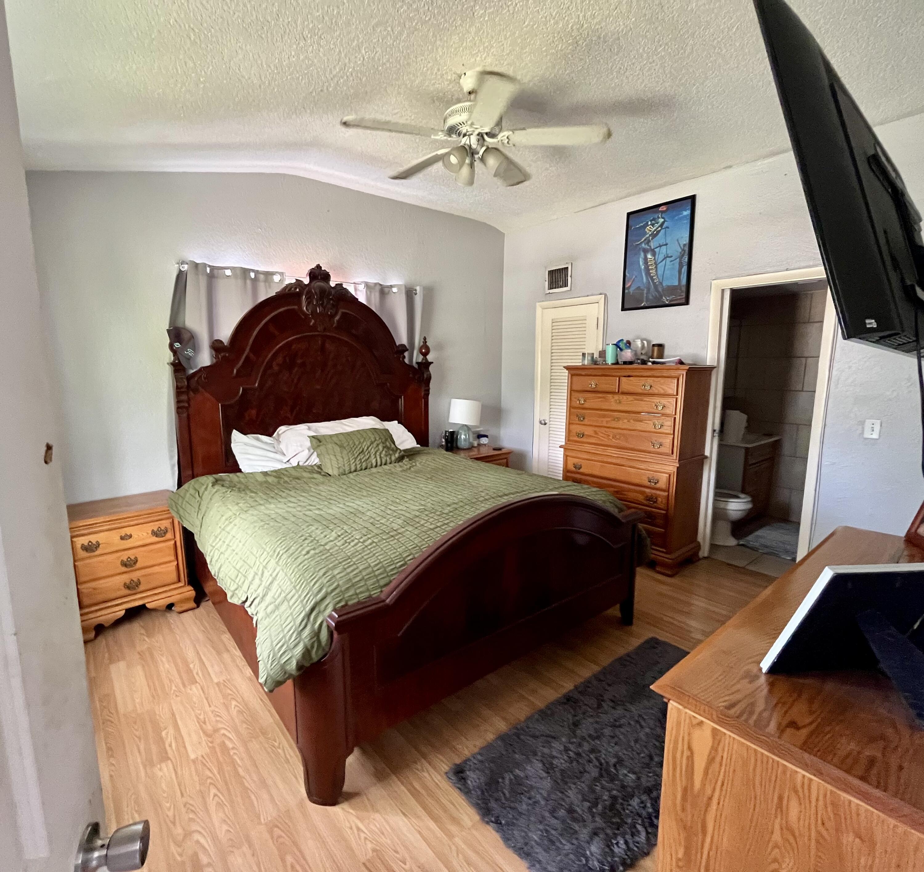 1424 Crest Drive Lake Worth, FL 33461 - Photo 6 of 16 a bedroom with a bed dresser and a window