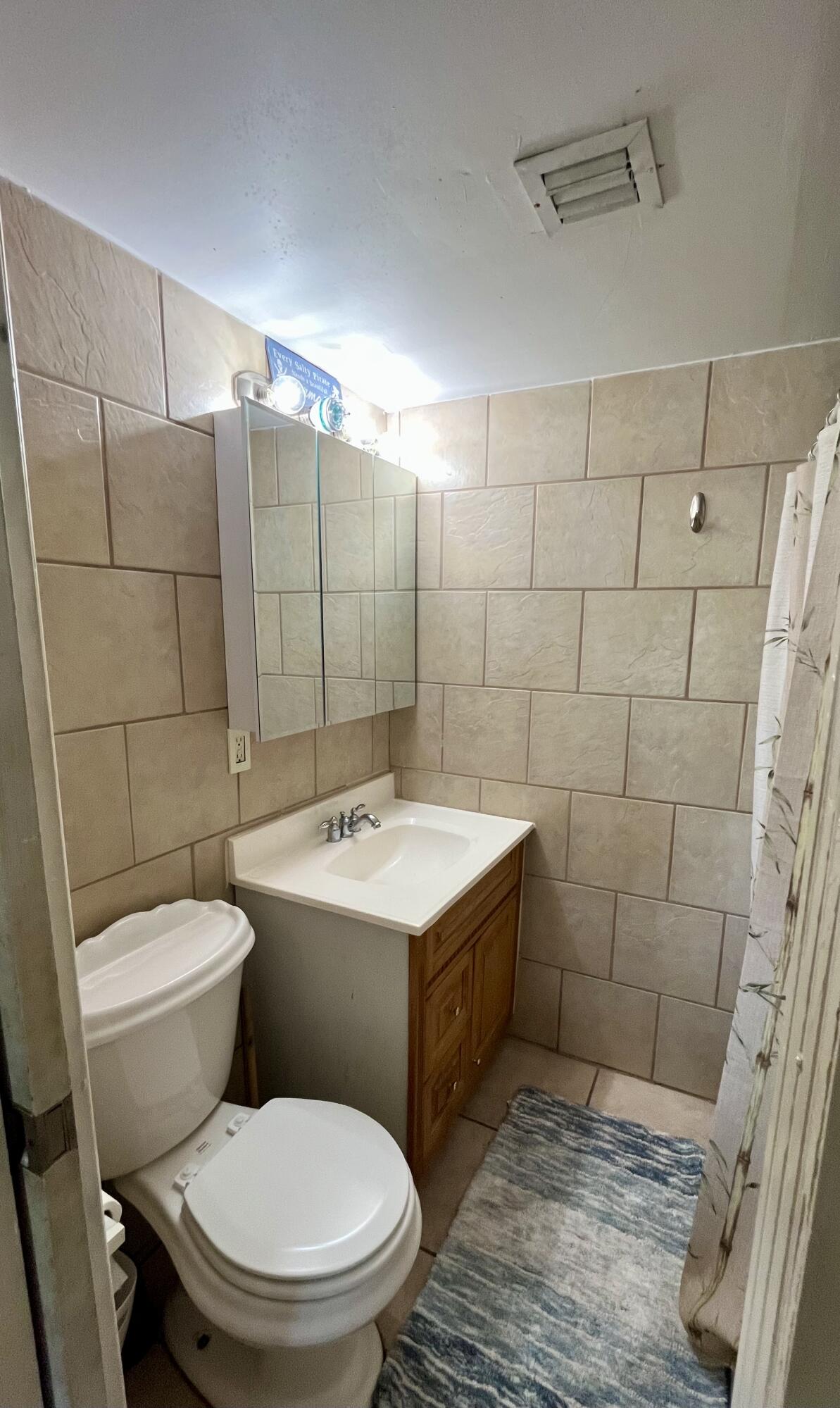 1424 Crest Drive Lake Worth, FL 33461 - Photo 9 of 16 a bathroom with a sink a toilet and shower