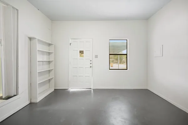 an empty room with a empty space and windows