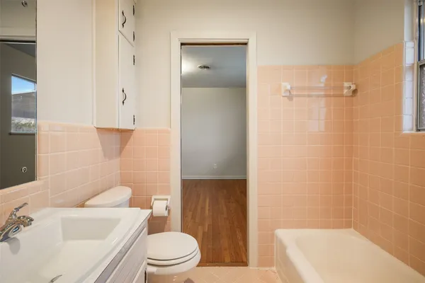 a bathroom with a toilet a sink and bathtub