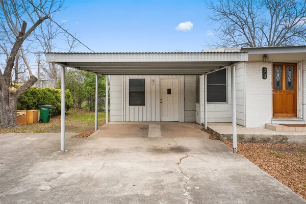 a view of a house with porch and furniture