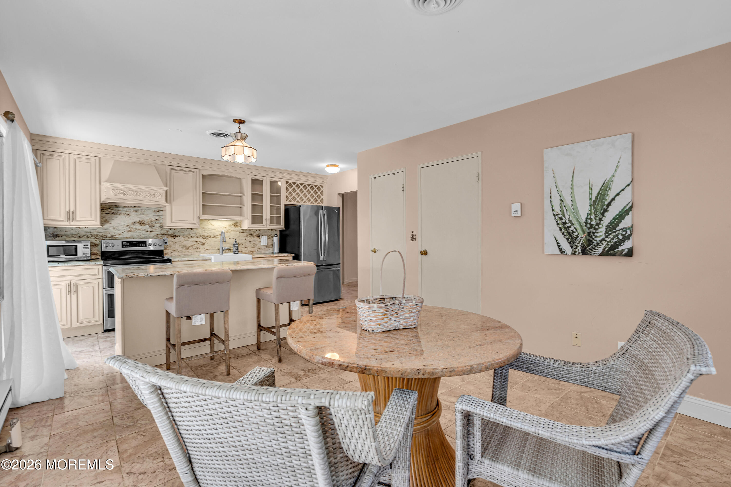 12 Vermont Way Whiting, NJ 08759 - Photo 11 of 27 a kitchen with white cabinets and chairs