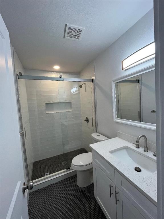 4020 Rawlins Street, Unit 102 Dallas, TX 75219 - Photo 7 of 11 a bathroom with a sink a toilet and shower