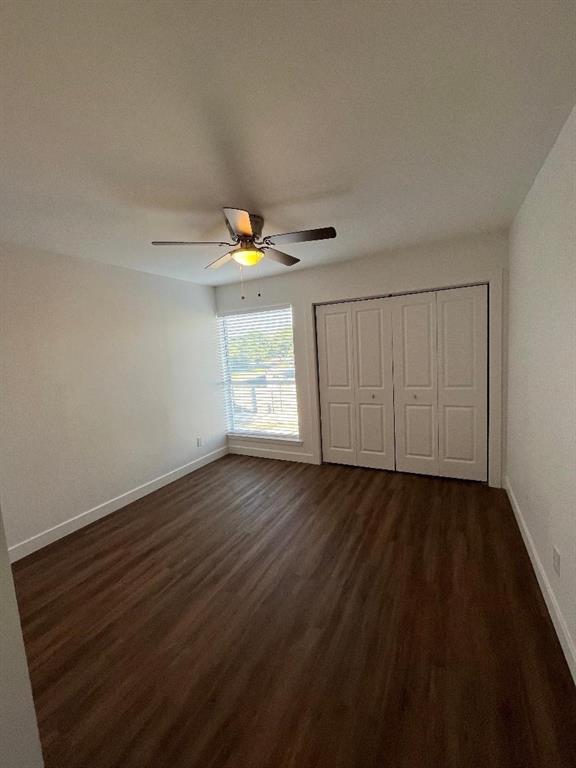 4020 Rawlins Street, Unit 102 Dallas, TX 75219 - Photo 8 of 11 a view of an empty room with wooden floor and a window