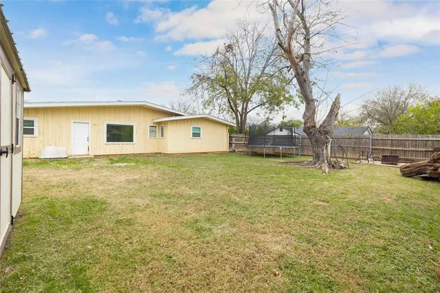 a view of house with backyard