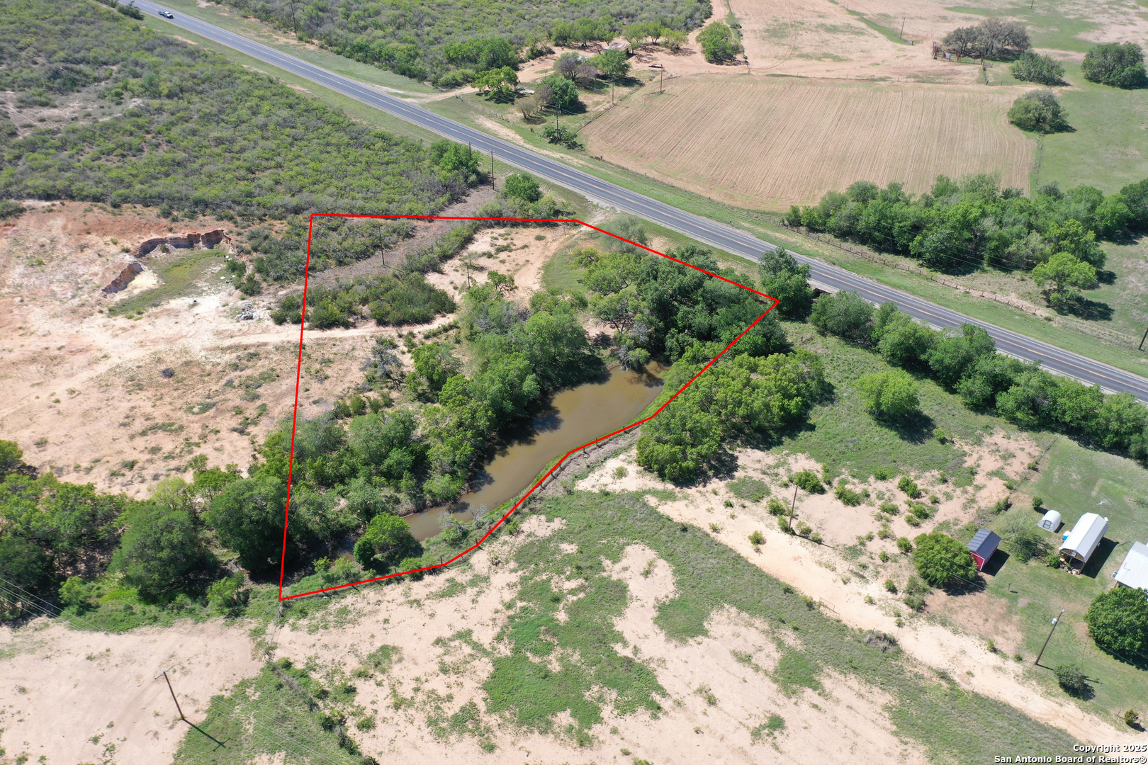 3894 South State Highway Devine, TX 78016 - Photo 8 of 8 a view of a garden with a pathway
