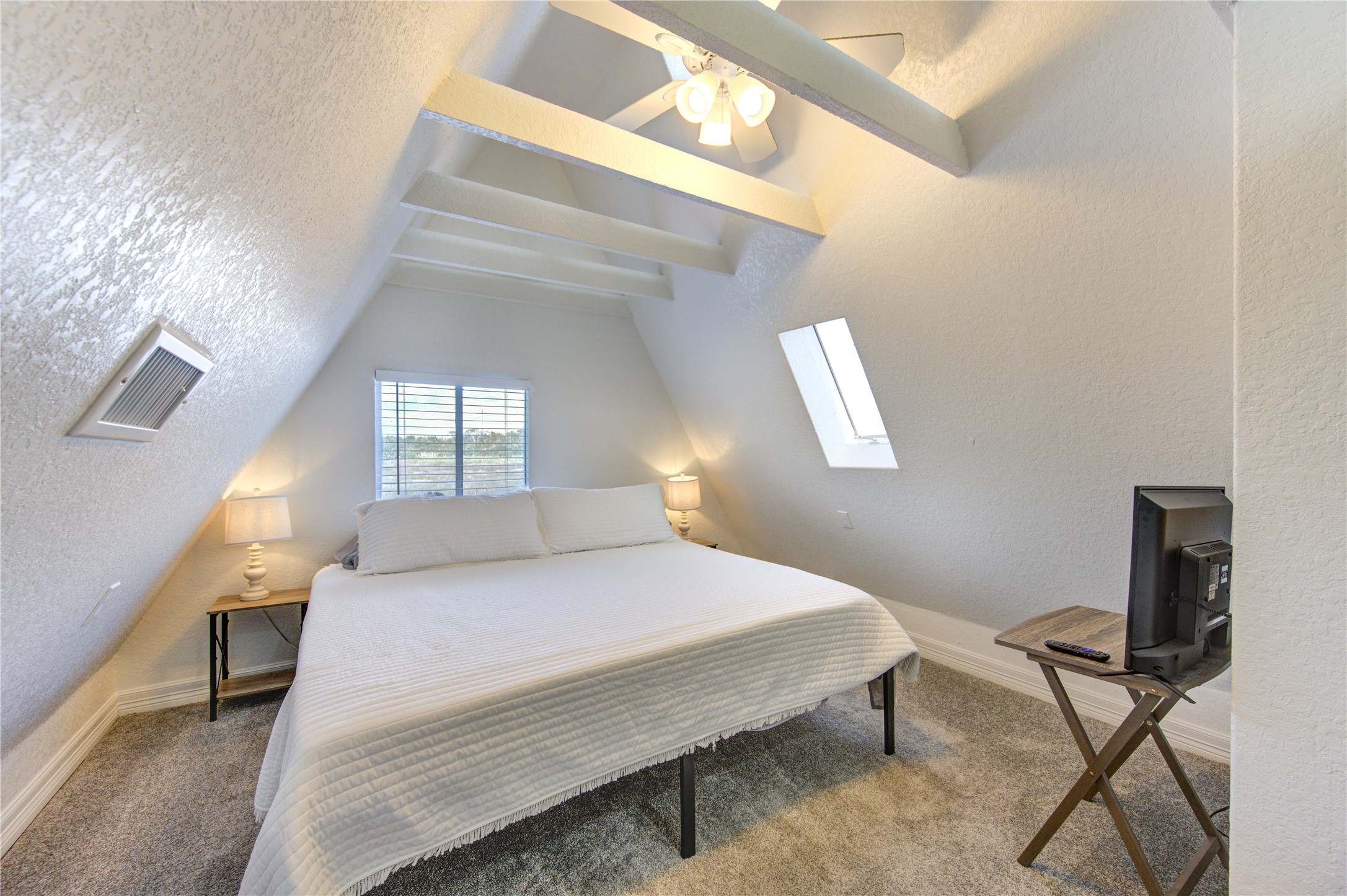 239 Redfish Drive Freeport, TX 77541 - Photo 13 of 25 a bedroom with a bed and a window